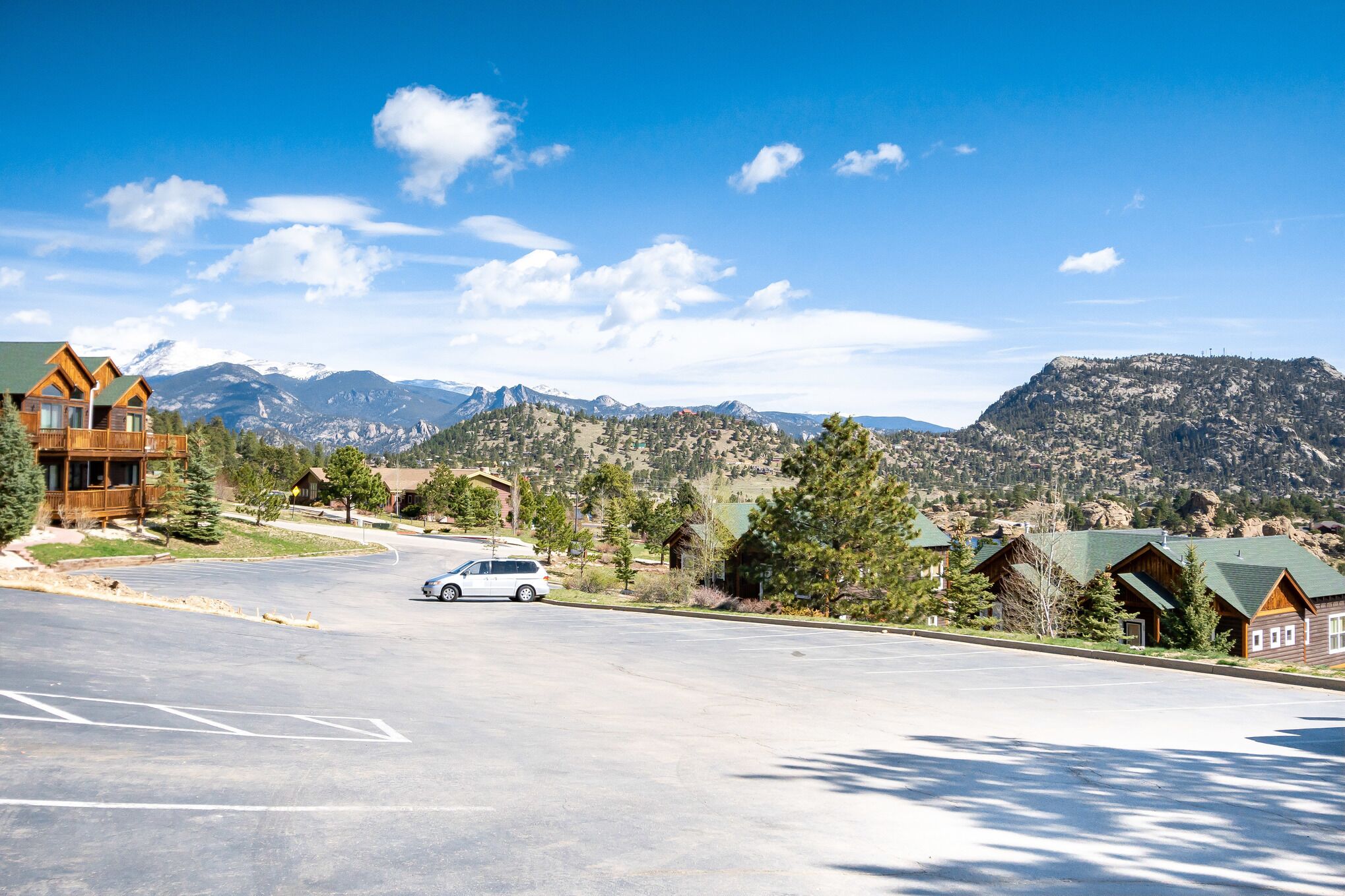 A spacious parking lot with a white car parked in the center.