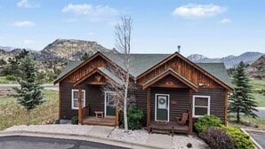 A log cabin with two separate entrances, each with a door and a small porch.