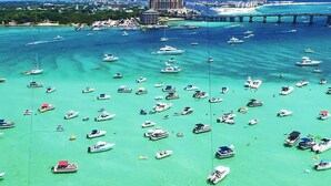 A marina with numerous boats docked in clear turquoise water.