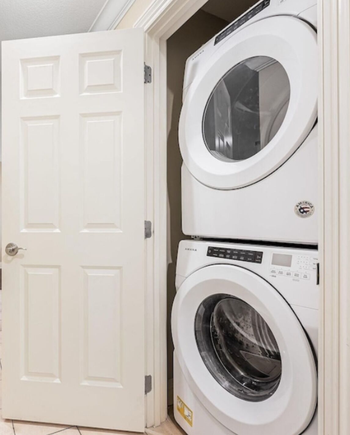 A laundry room with two stacked front-loading washing machines.