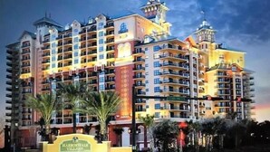 A multi-story hotel with a sign reading "Harborwalk Village."
