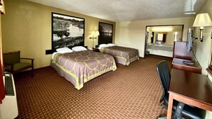A hotel room with two beds, a desk, a chair, a desk lamp, and a large mirror. - Super 8 By Wyndham Shawnee (Shawnee)