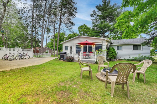 A house with a porch, a grill, and bicycles parked outside. - Boyne City Retreat Near Beaches & Mtn Resort! (Boyne City)