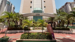 A tall building with a central entrance archway labeled "1955" and "SARS CREMATION".