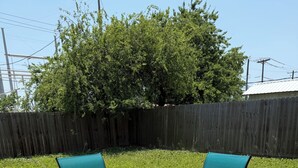 A deck with two chairs and a small table.
