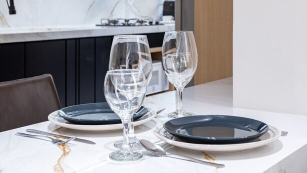 A modern kitchen with a marble countertop, dark cabinets, and a stainless steel range hood. - Perfect for couples in Ipanema | VP802 (Rio de Janeiro)