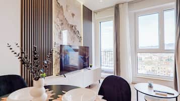 Deluxe Apartment | Living area | 42-inch Smart TV with cable channels