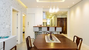 A modern dining area with a wooden table, chairs, and a decorative centerpiece.