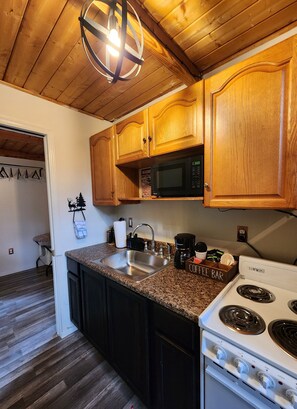 Fridge, microwave, coffee/tea maker, cookware/dishes/utensils