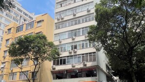 A multi-story building with a ground-level commercial space, including a visible storefront with signage. - 3 minutes from Copacabana beach | NSC904 (Rio de Janeiro)
