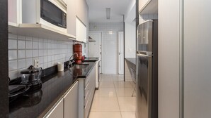 A modern kitchen with a microwave, coffee maker, and refrigerator. - For families, 3 minutes from Copacabana beach | SL501 (Rio de Janeiro)