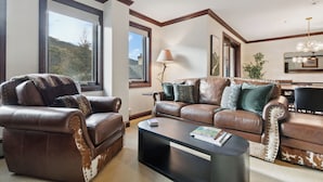 A living room with a brown leather sofa, a matching armchair, a black coffee table, and a dining area with a table and chairs. - Spacious 2BD + Den, Ski In Out
In the Heart of Beaver Creek Village
Pool jacuzzi (Beaver Creek)