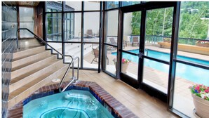 A hot tub area with a view of a pool and outdoor seating. - Spacious 2BD + Den, Ski In Out
In the Heart of Beaver Creek Village
Pool jacuzzi (Beaver Creek)