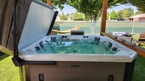 A hot tub with a control panel and a brand name 'MARQUIS'. - Beautiful Modern Farmhouse
 (Keizer)