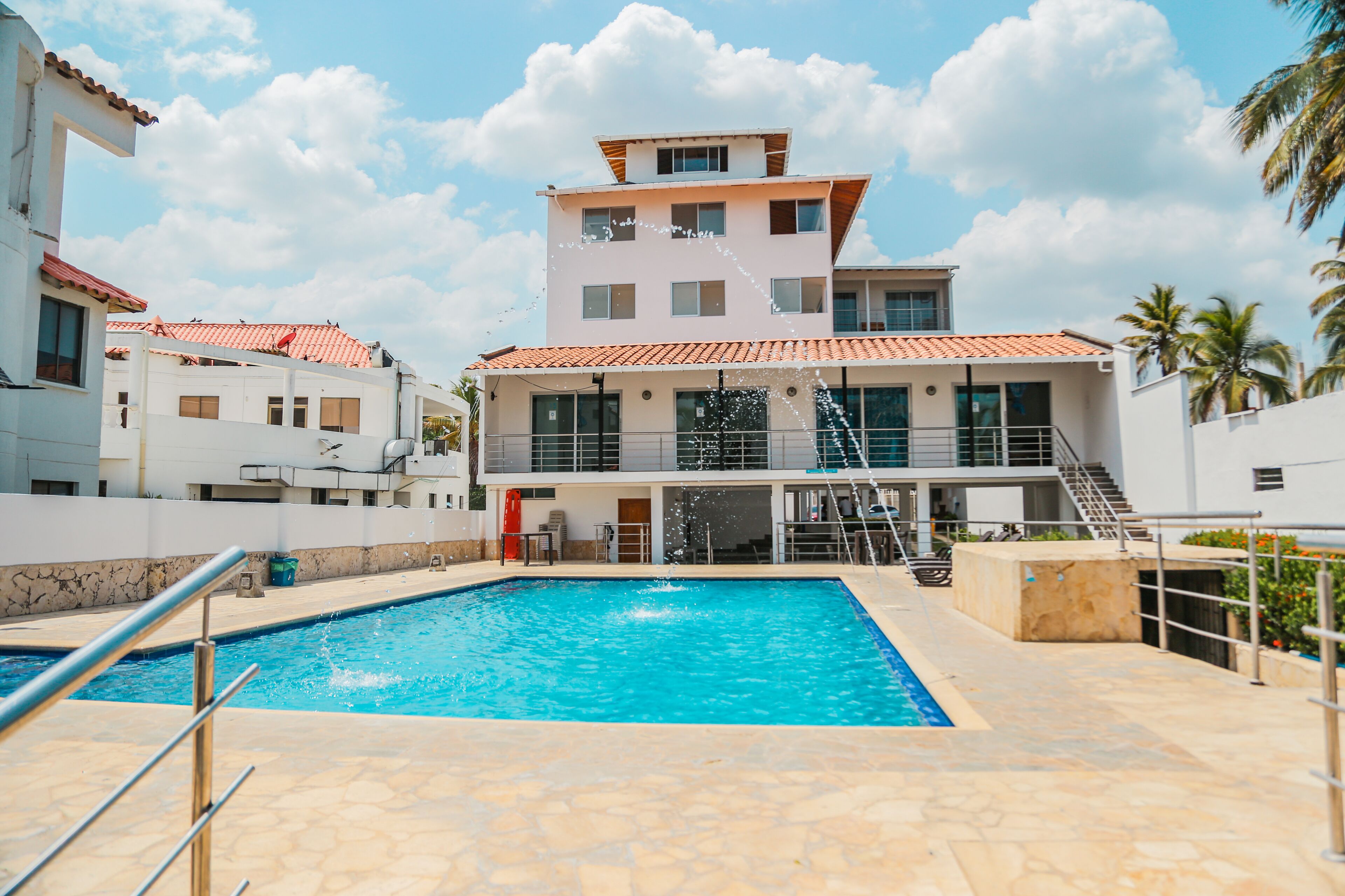 A swimming pool area with a multi-story building in the background.