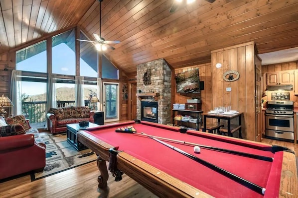 A cozy lodge with a pool table, a fireplace, and a dining area. - King Bed, Pool Table, Hot tub, Vinyl Record Player, Covered Back Porch w VIEWS!! (Sevierville)