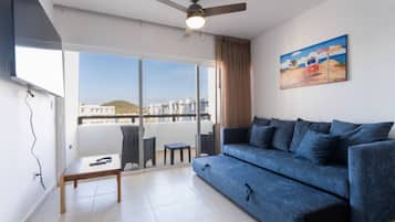 Standard Condo | Living area | 50-inch flat-screen TV with digital channels, Netflix