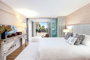 A bedroom with a bed, bedside lamps, a dresser, and a view of the outdoor area. - Stunning apartment - 211 with views of Bondi Beach (Bondi)