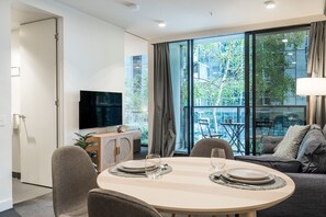 City Apartment | Living area | 35-inch Smart TV with digital channels, Netflix, streaming services - StayCentral - Oasis on Mackenzie (Melbourne)