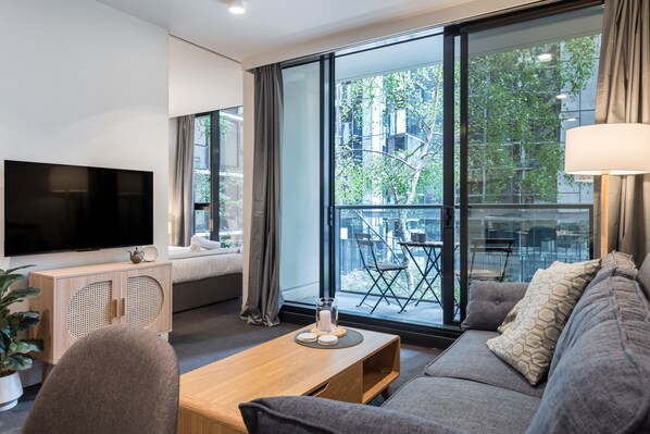 City Apartment | Living room | 35-inch Smart TV with digital channels, Netflix, streaming services - StayCentral - Oasis on Mackenzie (Melbourne)