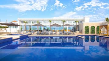Outdoor pool, open 10:00 AM to 10:00 PM, pool umbrellas, pool loungers
