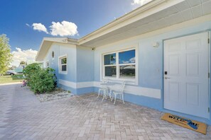 Welcome to a serene suburban retreat with a cozy porch and inviting entrance.