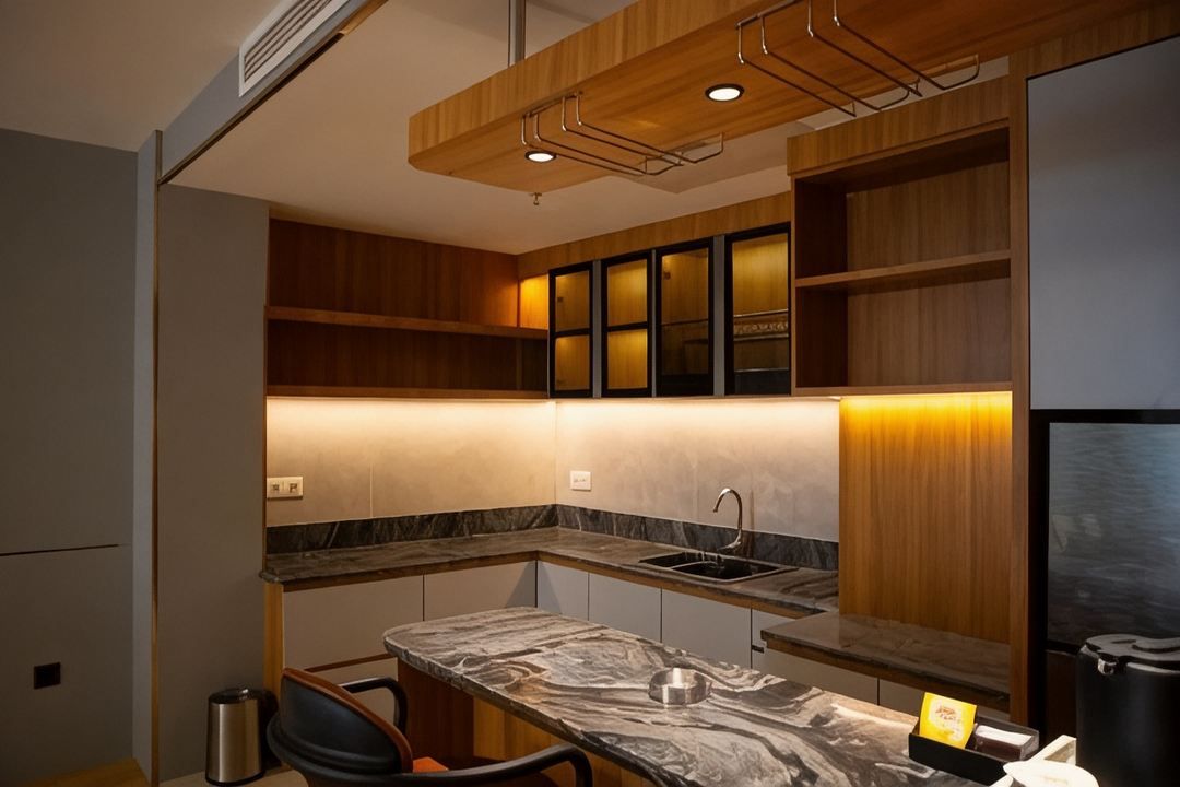 A modern kitchen with wooden cabinetry, a marble countertop, and built-in lighting.