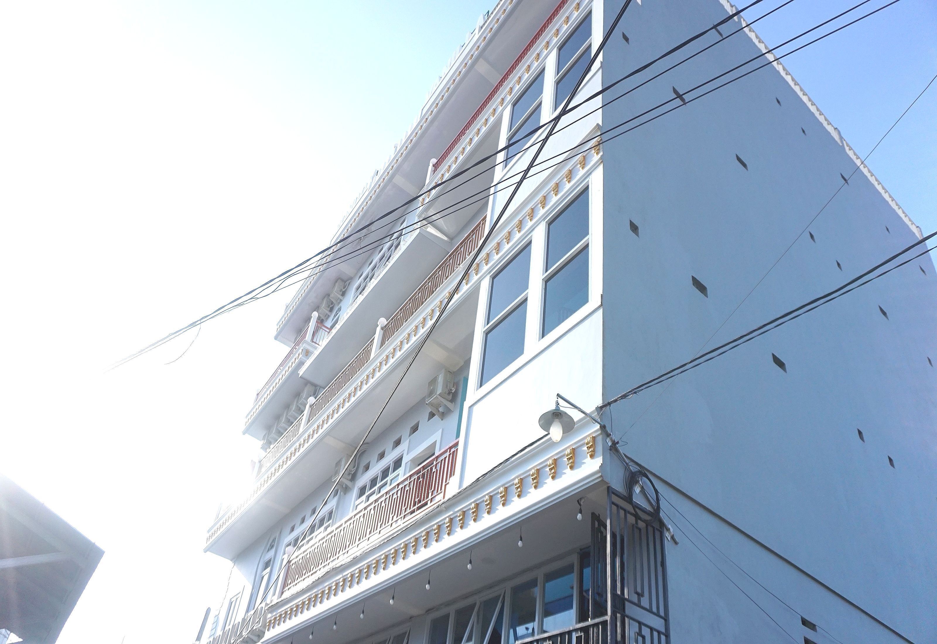 A multi-story building with balconies and railings.