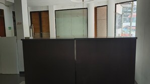 A hotel reception area with a check-in counter, a staircase, and a view of the outside. - Hotel O Nilam Guest HouseNearYani Heahlerr (Marabahan)