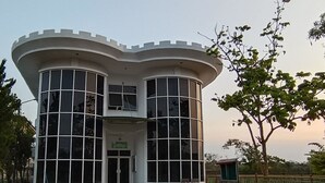 A modern building with a curved roof and large windows. - Hotel O Nilam Guest HouseNearYani Heahlerr (Marabahan)