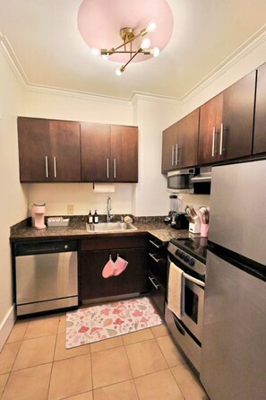 Enjoy cooking in this kitchen with an oven, coffee maker, and microwave.