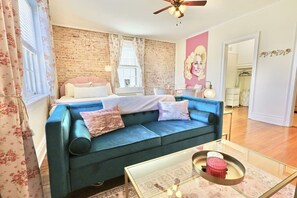 Relax in this stylish living room with a sofa, coffee table, and large window.
