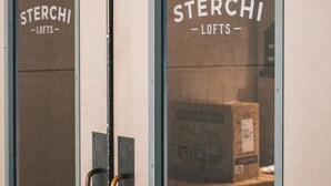 A door with the text "STERCHI - LOFTS" on it, indicating a loft-style accommodation. - Urban Retreat w/ Downtown Views (Knoxville)