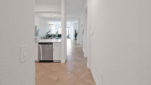 A modern kitchen with a dishwasher, a sink, and a countertop. - Lakefront villa -  pet friendly - near beaches - Hibiscus Haven (Englewood)