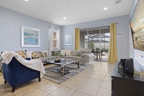 TV, fireplace, table football - Bright Resort 7BR Home w/ Pool • Kid Friendly • Near Disney (Kissimmee)