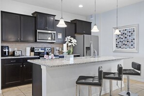 Fridge, microwave, oven, stovetop - Bright Resort 7BR Home w/ Pool • Kid Friendly • Near Disney (Kissimmee)