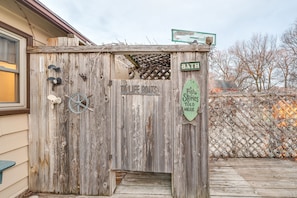 A rustic wooden structure with a sign reading "TOILET BOATS" and another sign indicating "BATH". - Clear Lake Vacation Rental: Walk to Town / Beach! (Clear Lake)