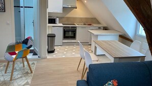 A compact living space with a kitchen, dining area, and a cozy seating area.