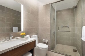 A modern bathroom with a glass shower enclosure, a white sink, and a mirror. - Citadines Nanhai Foshan (Foshan)