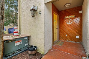 A wooden door with a sign reading 'Beach House' and a number '15' on the wall.