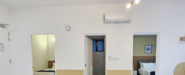 A hotel room with a bed, a bathroom, and a hallway. - Cubic Botanical Premium Suites atBangsar (Kuala Lumpur)
