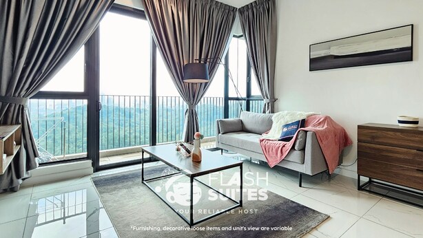 A modern living room with a sofa, coffee table, and a view of a mountainous landscape through large windows. - Cubic Botanical Premium Suites atBangsar (Kuala Lumpur)