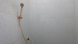 A shower area with a handheld showerhead and a handheld hose. - Hotel O Intan HomestayNearAnugrah Sinar Lautan (Batam)