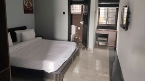 A bedroom with a bed, a desk, and a chair. - The Crib-Artist Residence (Port Harcourt)