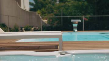 Seasonal outdoor pool, open 8:00 AM to 7:00 PM, pool umbrellas
