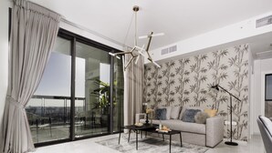 A modern living room with a sofa, coffee table, and floor lamp.