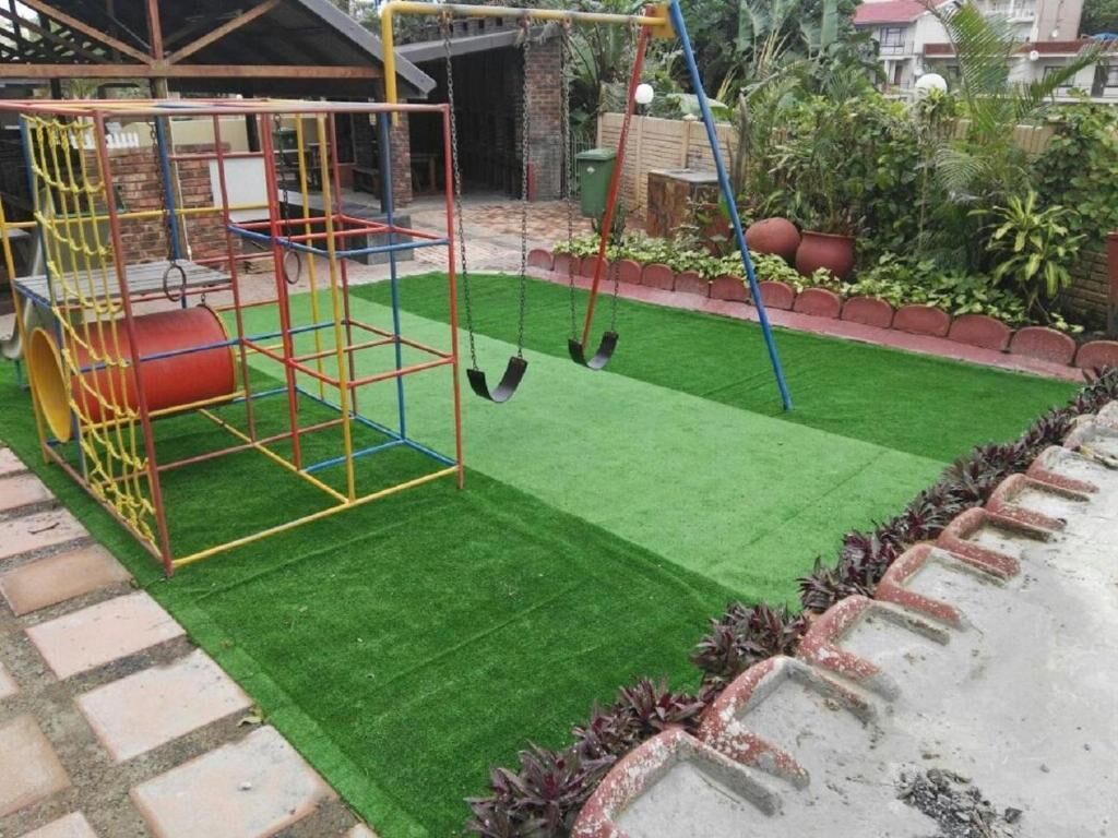 A playground with swings and a climbing structure.