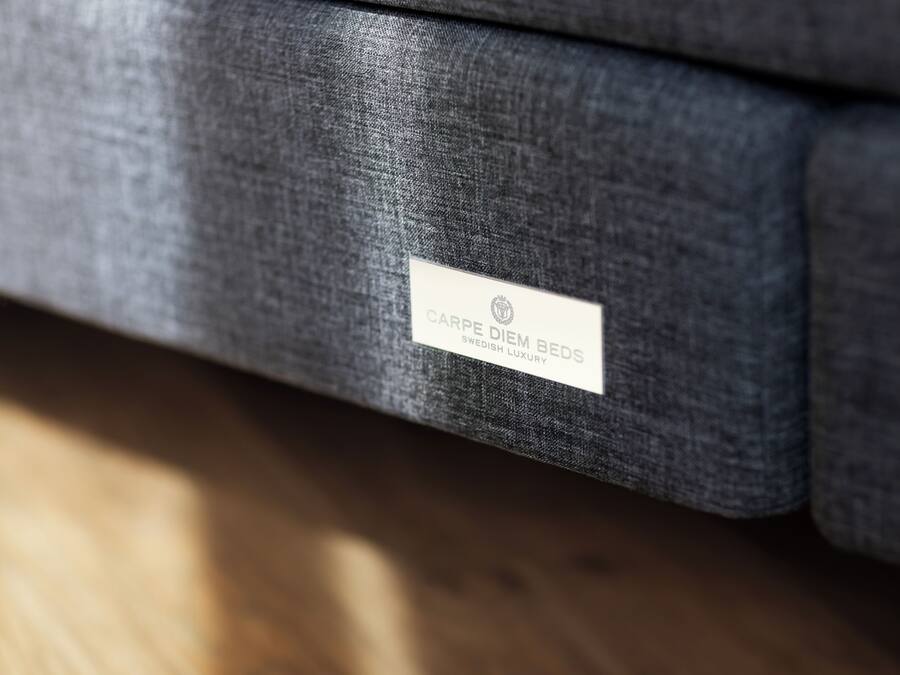 A label on a piece of furniture with the text "CARPE DIEM BEDS SWEDISH LUXURY".