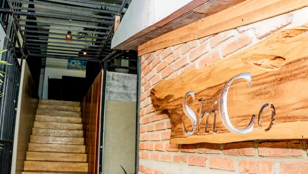 A staircase leading to a wooden wall with the name "SITCo" carved into it. - ShiCo Transit Hotel (Seeduwa - Katunayake)