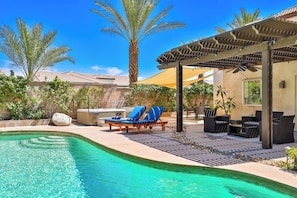 A swimming pool with lounge chairs, a pergola, and a patio area with outdoor furniture. - Private Saltwater Pool & Hot Tub Oasis w/ WiFi (La Quinta)